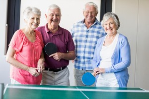 Seniors playing ping-pong in a retirement home